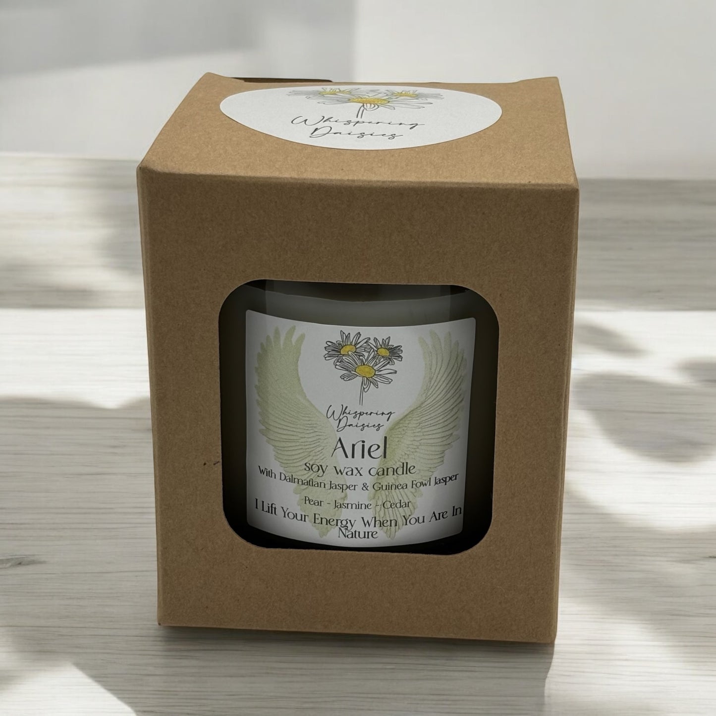 Ariel Angel Candle in a clear glass jar, topped with dalmatian jasper and guinea fowl jasper crystals, handmade soy candle from Whispering Daisies in North Devon.