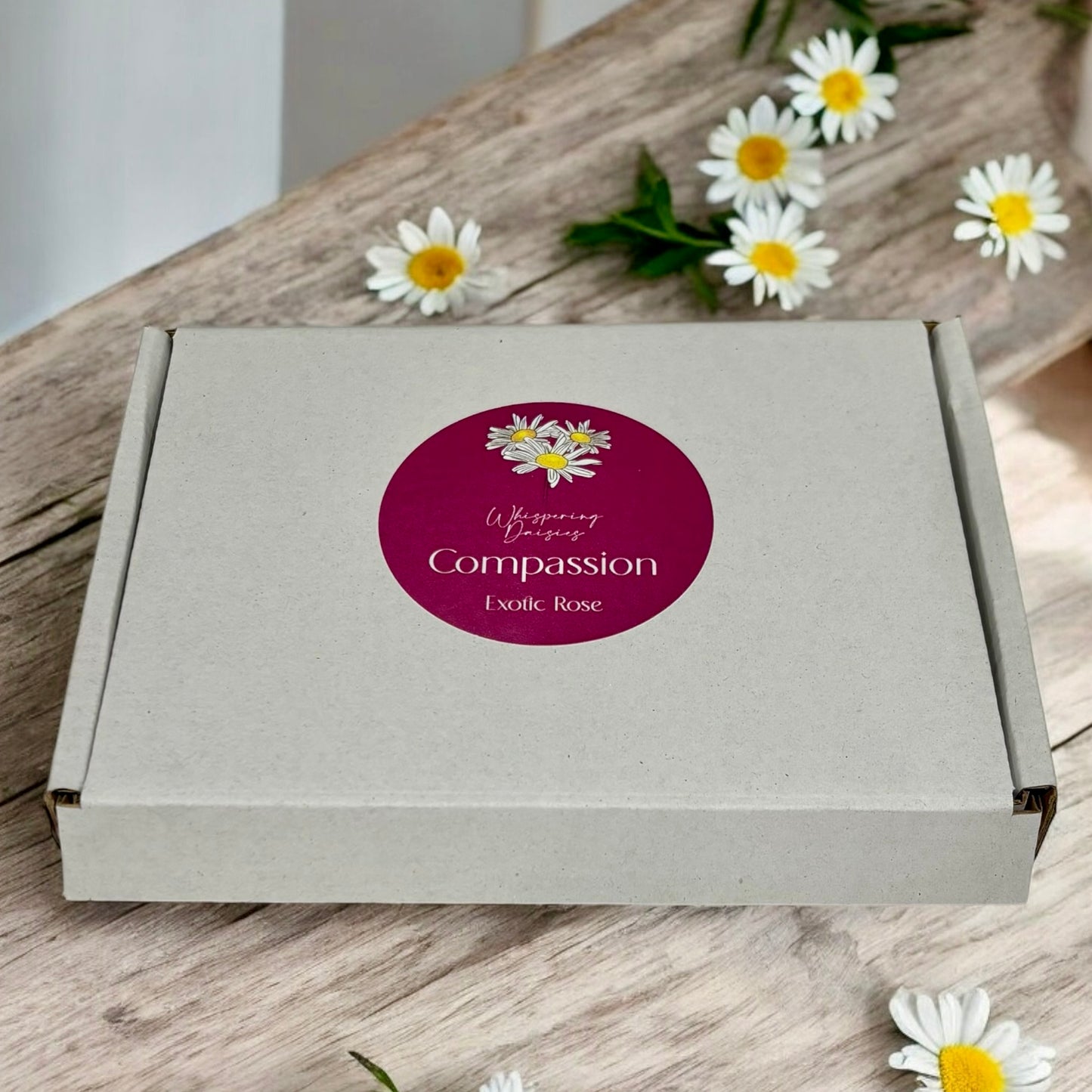 Compassion Daisy-Shaped Wax Melt Box of 5, handmade rose-scented wax melts by Whispering Daisies, wrapped in white paper.