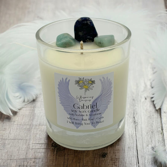Gabriel Angel Candle in a clear glass jar, topped with sodalite and amazonite crystals, handmade soy candle from Whispering Daisies in North Devon.
