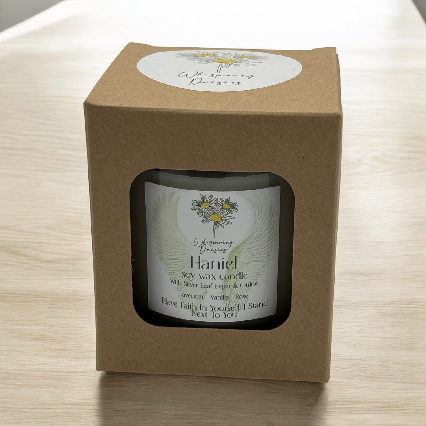 Haniel Angel Candle in a clear glass jar, topped with silver lead jasper and citrine crystals, handmade soy candle from Whispering Daisies in North Devon.
