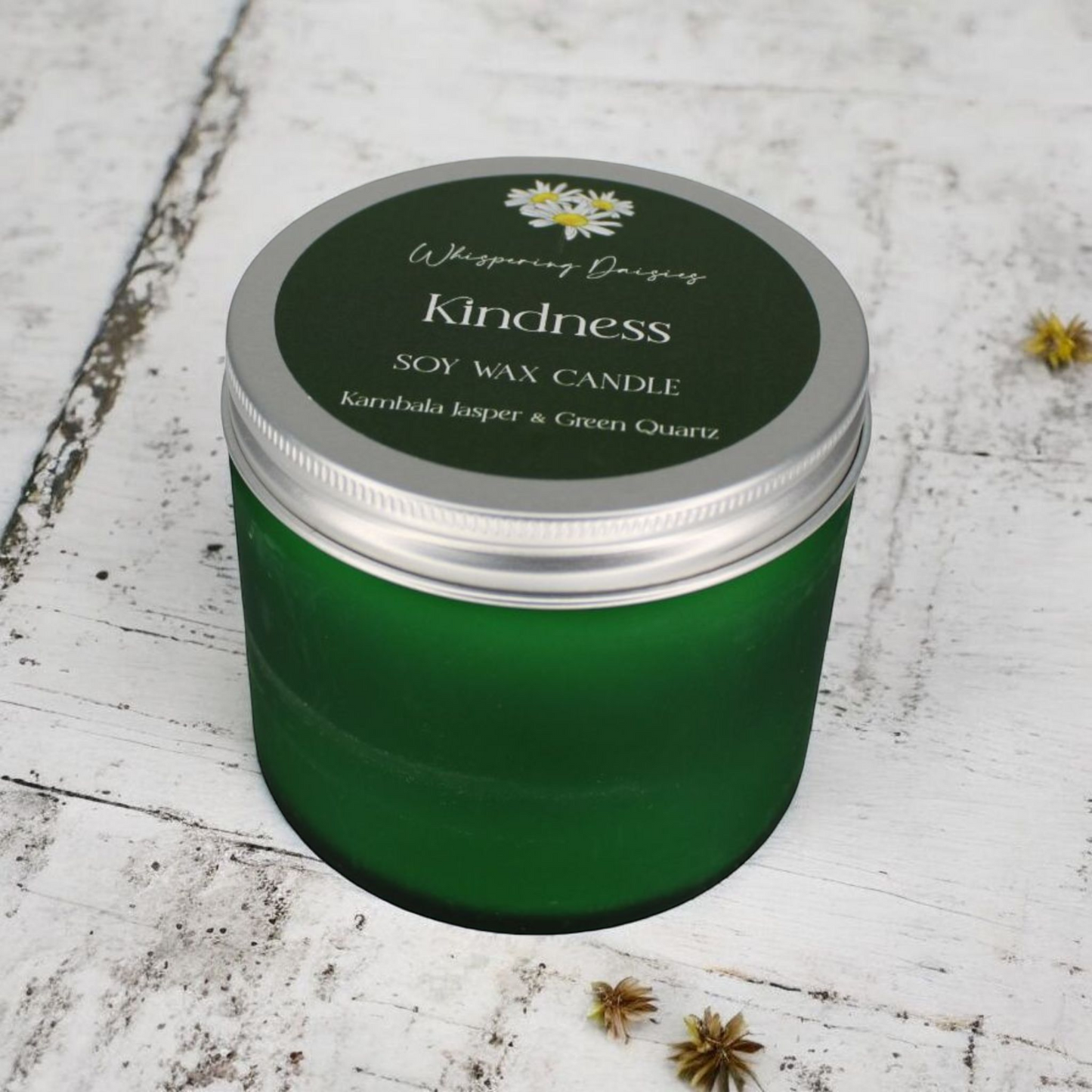 Kindness Candle infused with green quartz and kambala jasper crystals, floral almond scent, handmade in a glass container.