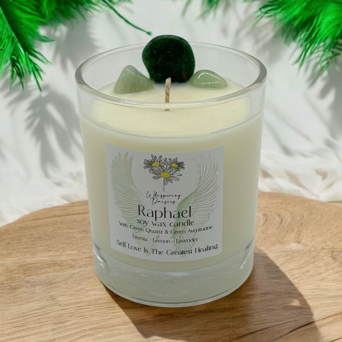 Raphael Angel Candle in a clear glass jar, topped with green quartz and green aventurine crystals, handmade soy candle from Whispering Daisies in North Devon.