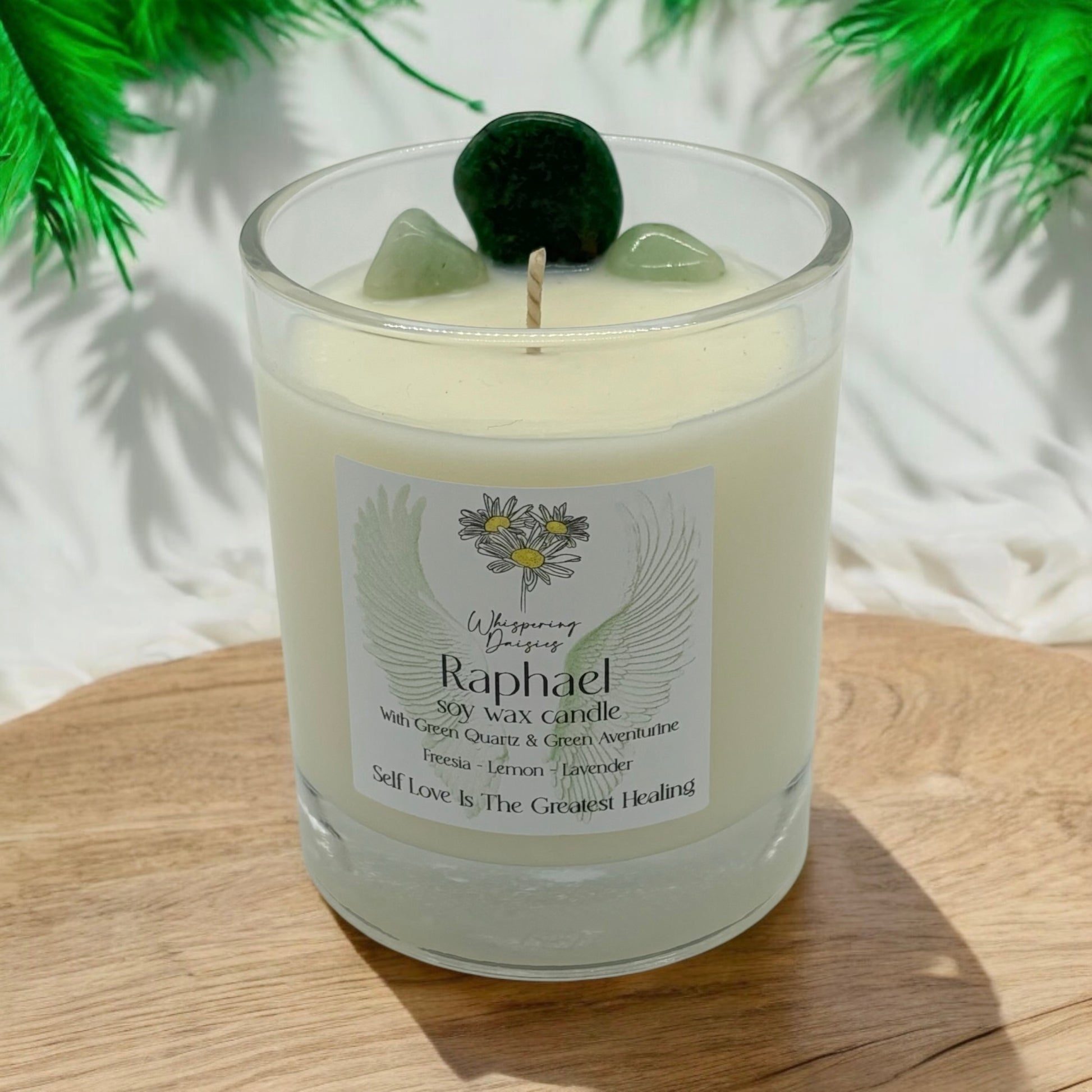Raphael Angel Candle in a clear glass jar, topped with green quartz and green aventurine crystals, handmade soy candle from Whispering Daisies in North Devon.