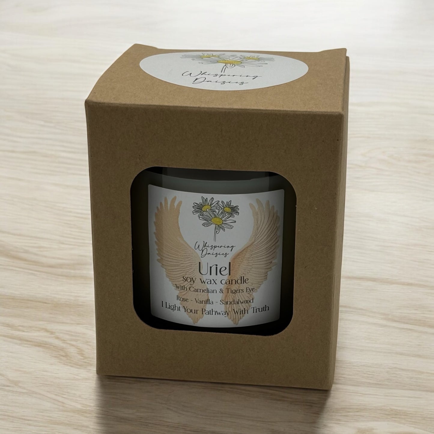 Uriel Angel Candle in a clear glass jar, topped with carnelian and tiger’s eye crystals, handmade soy candle from Whispering Daisies in North Devon.